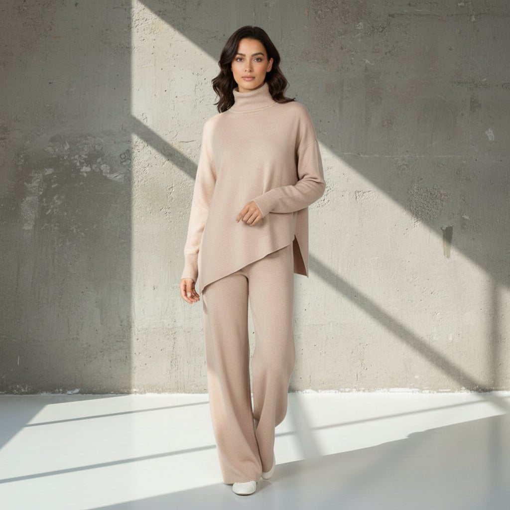 Woman wearing a beige turtleneck sweater and pants on a light gray background