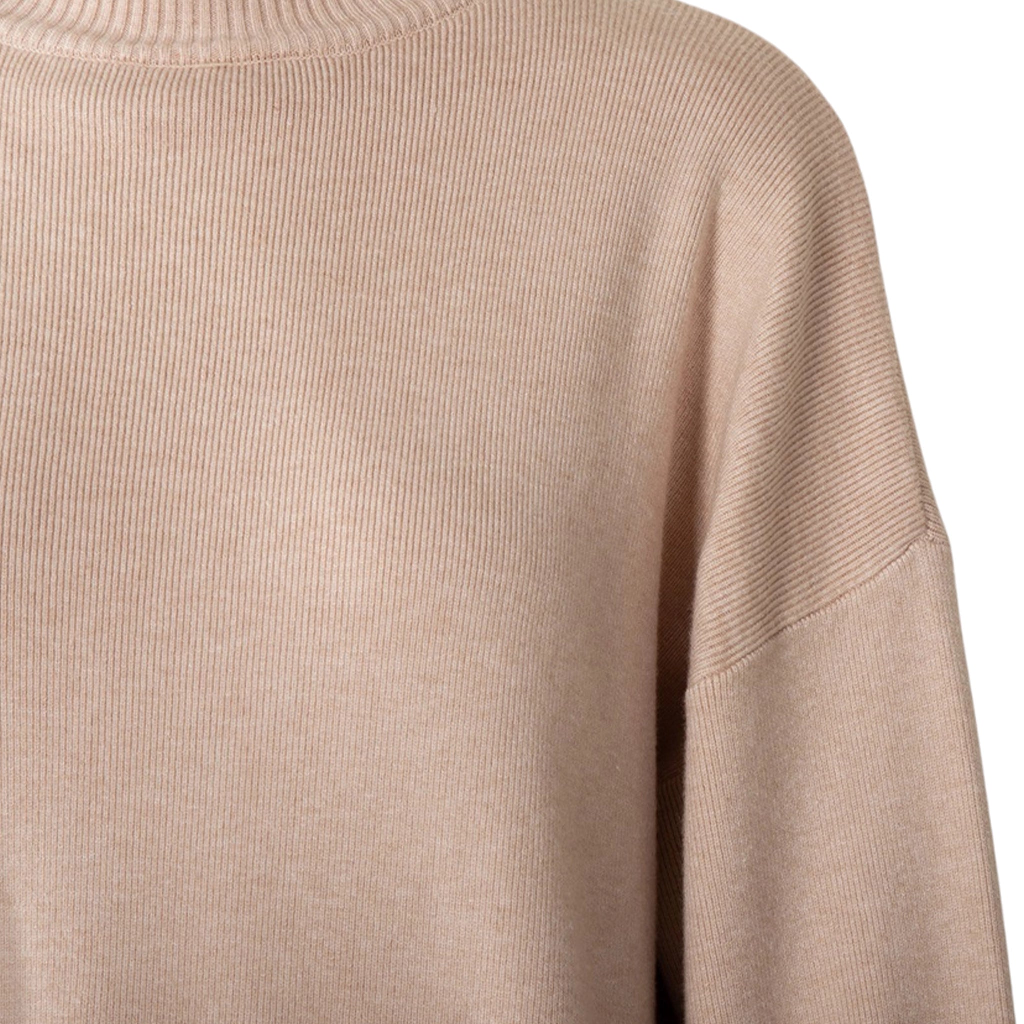 Close-up of a beige sweater sleeve on a white background