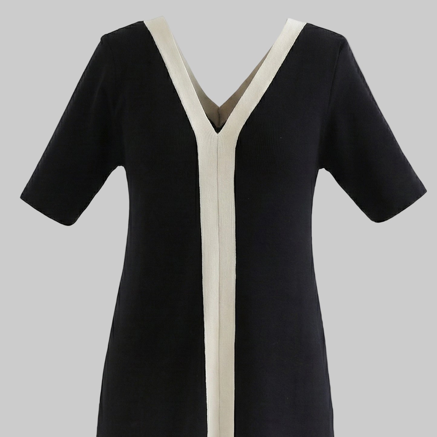 Black dress with white trim on a white background