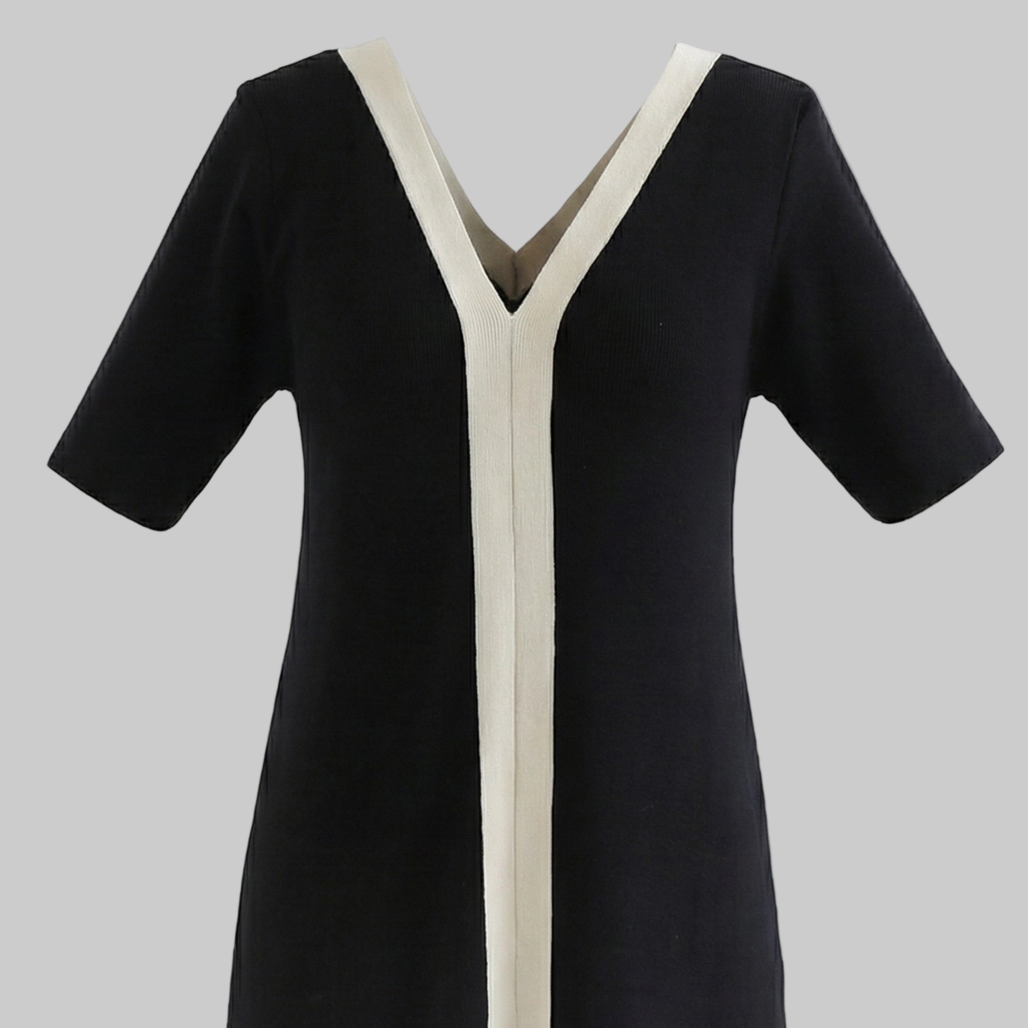 Black dress with white trim on a white background