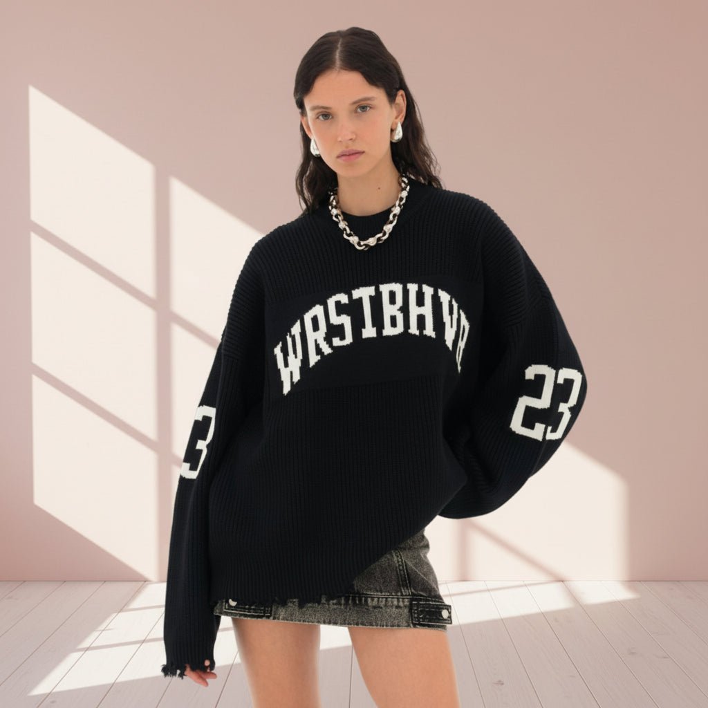 Person wearing a black sweater with 'WASTBHVN' and number '23' on a gray background