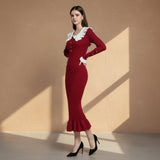 Red dress with white lace collar worn by a model on a gray background