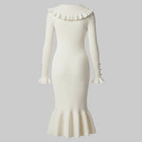 White ribbed dress with ruffled collar and hem on a white background